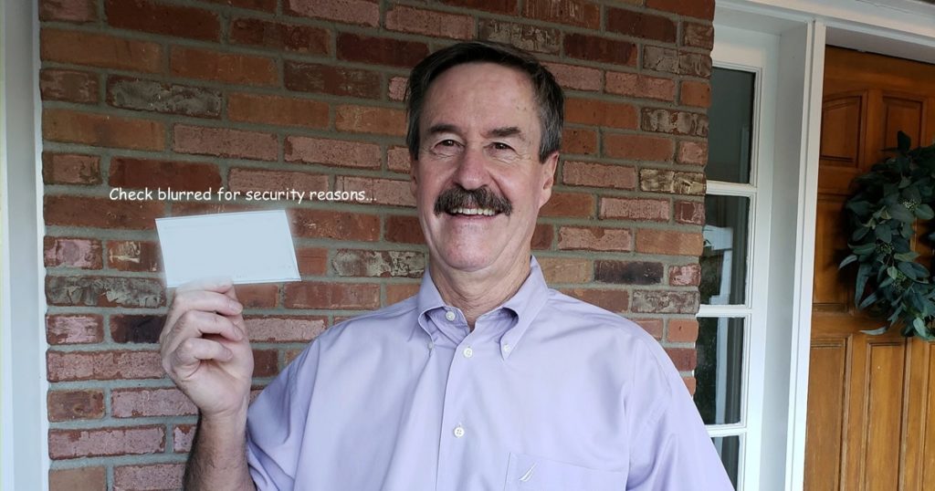 Jack Zoellner, the relational leadership speaker, and Here Next Year speaker mentoring client, holding his first check as a professional speaker